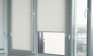details,of,white,fabric,roller,blinds,on,the,plastic,window